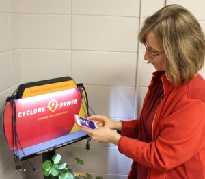 Chemical and Biological Engineering undergraduate Catherine Le Denmat checks out the new "Cyclone Power" charging station in the Mike & Jean Steffenson Student Services Center