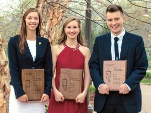 Erica Vaassen (left), Rebecca Harmon and Eli Reiser pose with plaques they received during a ceremony for the Dean's Student Leadership Awards.