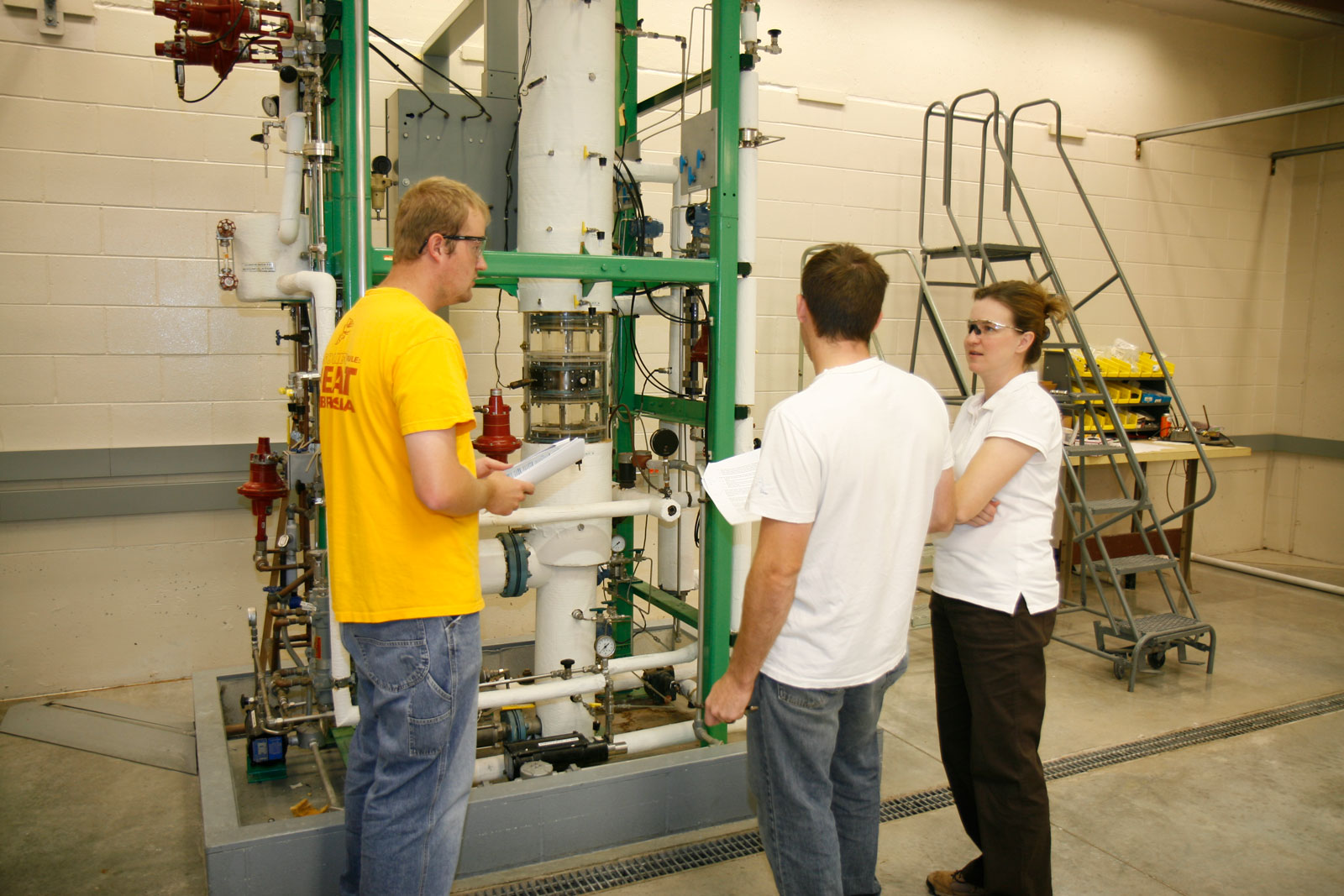 Students and faculty working on equipment